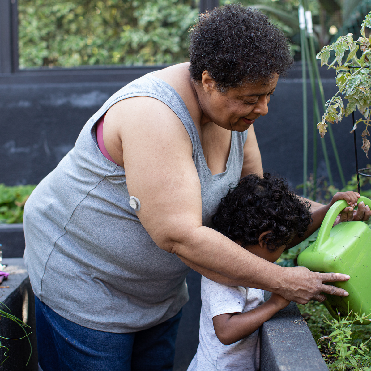 Dexcom G7 customer with her grandchild in the garden.